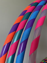 Load image into Gallery viewer, Colorful hula hoops with striped patterns on a neutral background