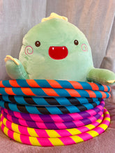 Load image into Gallery viewer, 4 colourful weighted fitness hoops coiled around jeremy the dragon