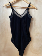 Load image into Gallery viewer, Front of black velvet body suit on hanger