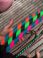 Load image into Gallery viewer, hula hoops in three colour combinations; pink, green, black, turquoise and orange