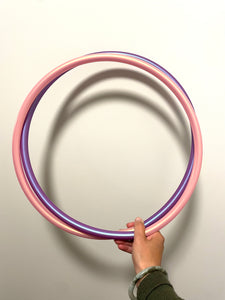 small pink and purple polypro hoop double coiled and held by a hand