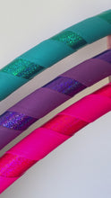 Load and play video in Gallery viewer, video of glittery hula hoops up close in pink purple and blue

