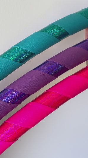 video of glittery hula hoops up close in pink purple and blue