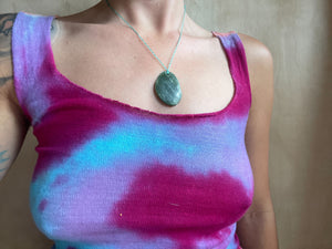 close up of woman wearing pink and blue tiedye top