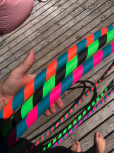 hula hoops in three colour combinations; pink, green, black, turquoise and orange
